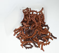 Ikea© plastic box filled with reddish brown Lego® Arch Bricks